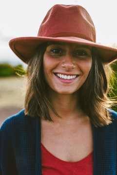 Portrait of a young hipster woman smiling outside.