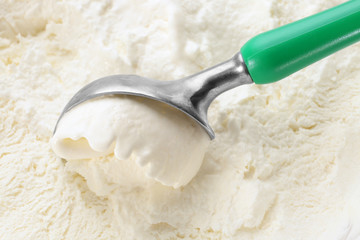 Scoop with delicious vanilla ice cream, closeup