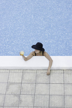 Portrait of a young female model at the swimming pool