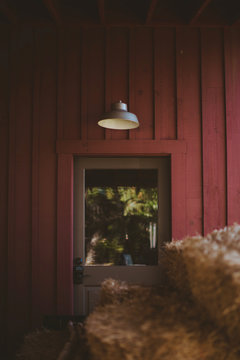 stack of hay in front of red barn