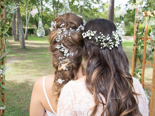 two girl with flowers in head for spring in wedding day, one is witness and bride