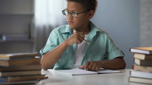 Boy with disability to learn reading and writing skills trying to concentrate