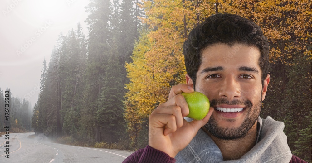 Poster man in autumn with apple in forest