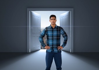 Businessman with hands on hips by open door to city