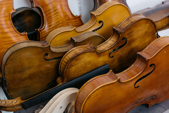 Various violin bodies to be repaired in a shop
