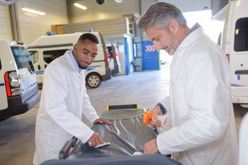 Ambulance men cleaning stretcher © auremar
