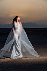 Fototapeta na wymiar Bride in sand dunes on mountain landscape
