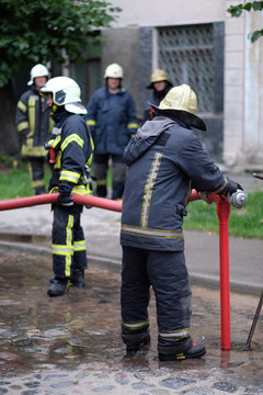Members of the fire brigade at the hydrant of water supply