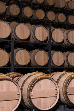 Barrels of wine stacked in a wine cellar