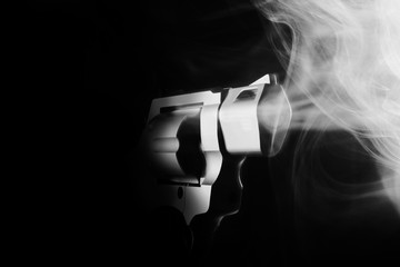 Smoking gun on black background