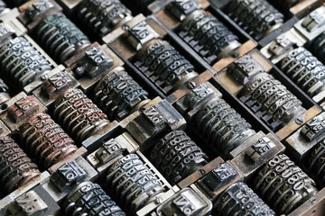 Close up background of vintage metal numbering inserts for printer, diagonal
