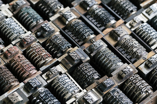 Close up background of vintage metal numbering inserts for printer, diagonal