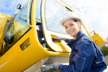 female worker getting into crane cab