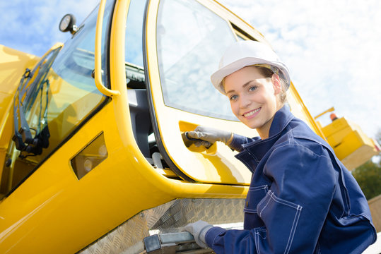 Female Worker Getting Into Crane Cab