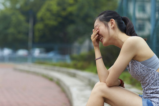 one happy young asian woman outdoor