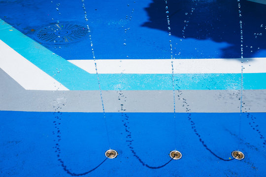 A view from above of a blue splash pad with strong modern lines.