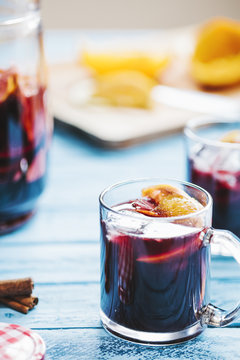 Detail shot of glass of sangria on a blue wooden background
