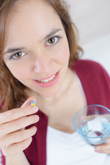 happy young woman taking pill