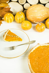 a slice of American pumpkin pie on Thanksgiving Day, decorated with pumpkin seeds. on a white table