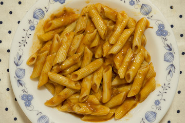 A cooked macaroni dish with bolognese