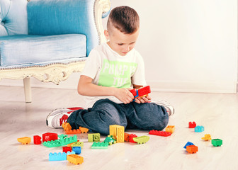 The boy is played on the floor