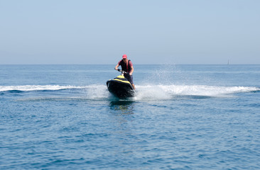Fototapeta na wymiar Man playing on a jet ski