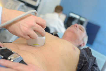 doctor analyzing male patient with abdomen ultrasound