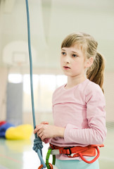 Active caucasian girl on the climbing wall