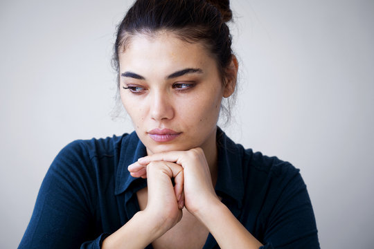 Portrait Of Unhappy Woman On Gray Background