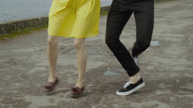 Happy couple dancing quickstep dance at the embankment. Energetic dance
