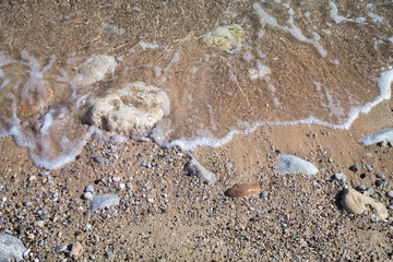 Waves on the shore seen from above and up