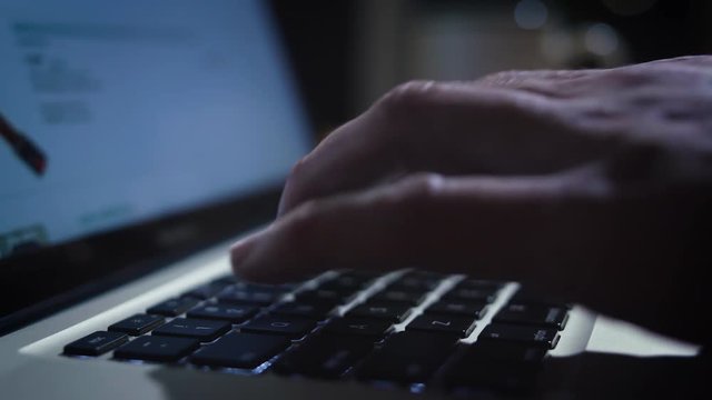 Fingers Typing Laptop Keyboard Browsing Computer at Night Drinking Tea