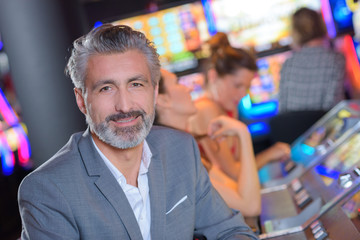 handsome man with slot machine in the casino