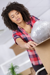 woman unpacking her online order in the living room