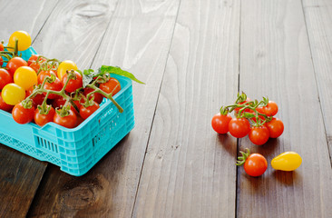 Fresh ripe tomatoes are in the boxes on broun wooden table