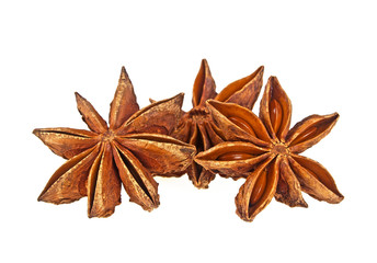 Three anise stars on a white background