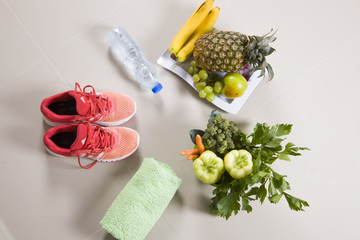 Sport shoes sneakers, water, measuring tape and apples on white background. Top view sport equipment. Healthy life and healthy food concept