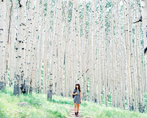 Woman walking in white tree forest