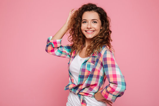 Portrait of happy woman posing isolated over pink