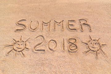 Handwritten inscription on the sand "summer 2018"
