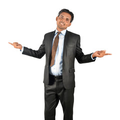 Businessman in black suit pointing happily over white background