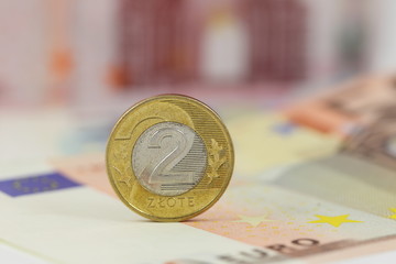 Polish coin 2 zloty over Euro banknotes. Poland and EU money.
