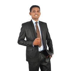 Portrait of a young smiling businessman in black suit standing over white background