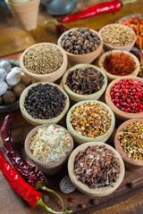 Variety of different asian and middle east spices, colorful assortment, on old wooden table