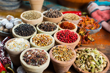 Variety of different asian and middle east spices, colorful assortment, on old wooden table