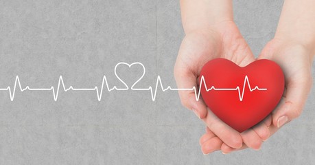 Heart beat over hands holding heart