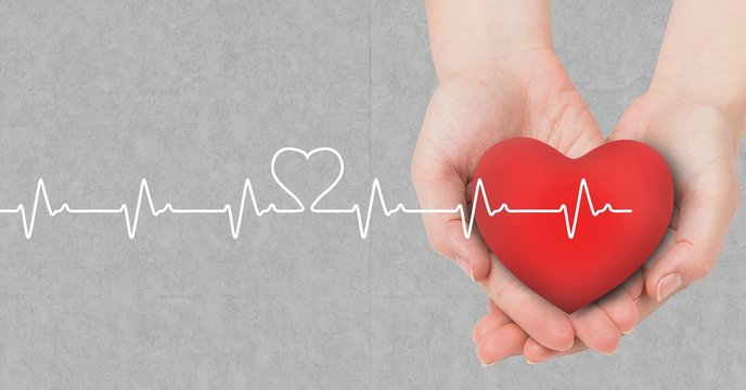 Heart beat over hands holding heart