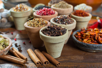 Variety of different asian and middle east spices, colorful assortment, on old wooden table
