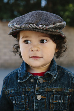 Portrait of a beautiful toddler boy with curly hair
