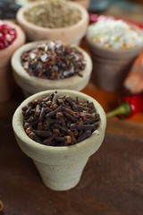 Variety of different asian and middle east spices, colorful assortment, on old wooden table